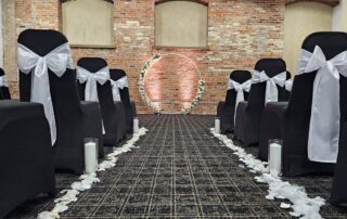 city centre events wedding setup with aisle and chairs and wreath