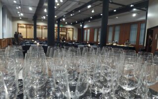 closeup view of wine glasses on table with meeting space in background